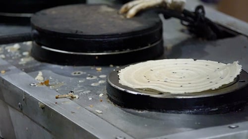 Gloved Hand Bakes Pastry on Appliance
