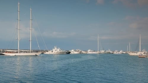 Luxury Yachts Docked in Marina on Sunny Day