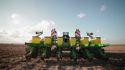 Agricultural Seeder Standing Still in Tilled Field