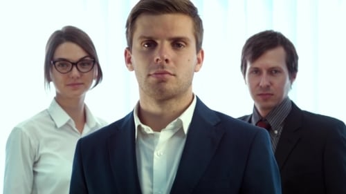 Team Of Three Successful Business People Looking