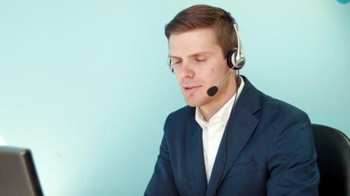 Man In Call Center Smilingly Looking At The Camera
