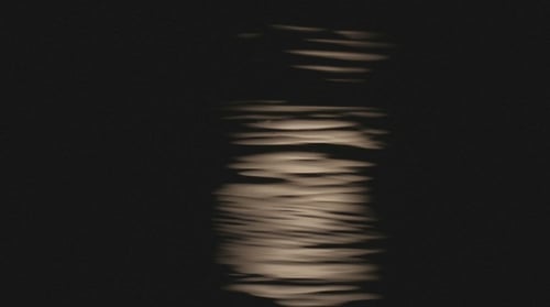Moonlight Reflecting off Gentle Dark Ocean Waves