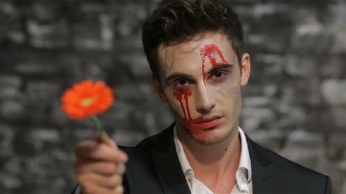 Young Adult with Halloween Makeup Offers Gerbera Daisy