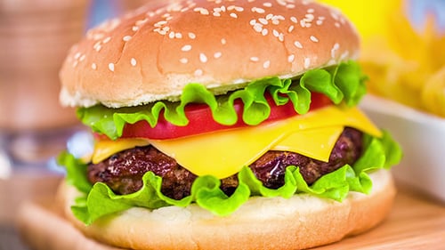 Delicious Cheeseburger on Wooden Cutting Board