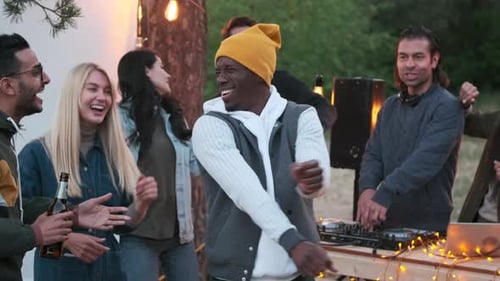 Friends Dancing with DJ at Outdoor Party