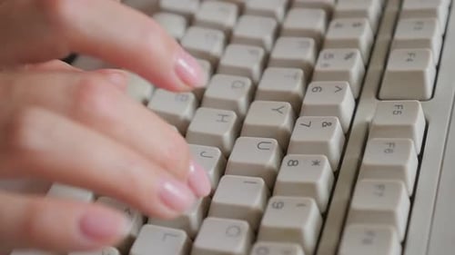 Close Up of Typing on Old Keyboard