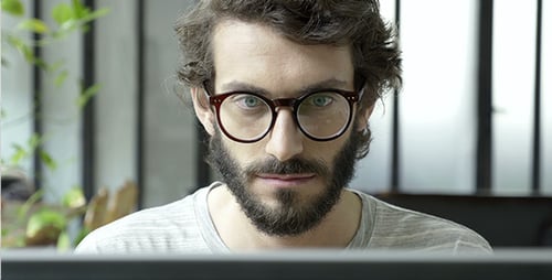 Bearded Man Looking at Computer Screen Indoors
