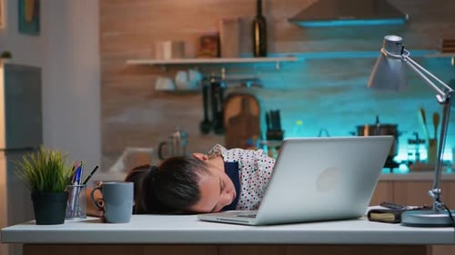 Overworked Woman Sleeping on Kitchen Desk