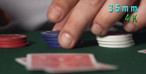 Hands Stacking Poker Chips on Table Close Up