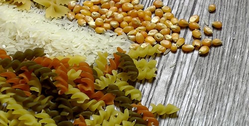 Uncooked Pasta, Rice, and Corn on Table