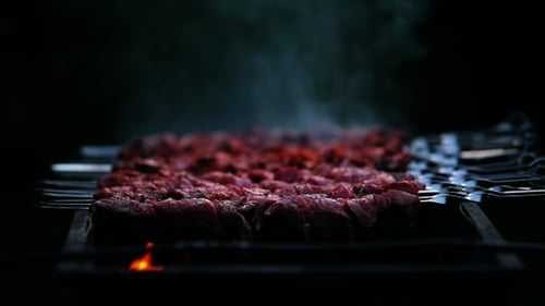 Barbecue Meat Sizzling on Grill with Smoke