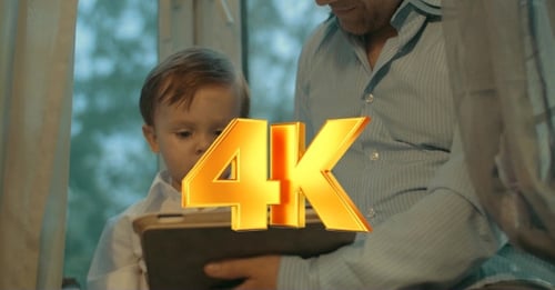 Young Child Using Tablet with Adult