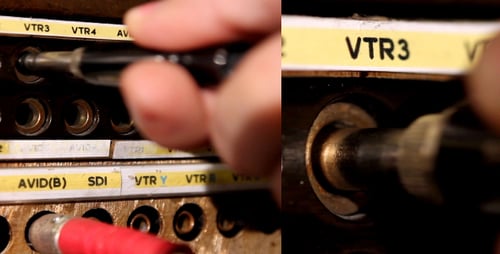 Hand Connecting Cable into Audio Visual Panel