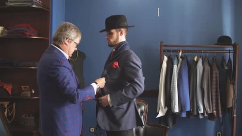 Mature Professional Tailor Taking Measure Leg Measuring of Client Customer