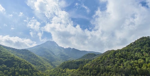 Lush Green Mountains Under a Cloudy Sky