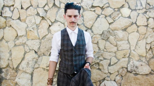 Man Puts on Suit, Sunglasses, and Fedora