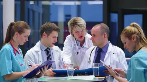 Medical Professionals Collaborating at Hospital Table