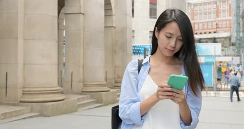 Woman Using Smartphone in Urban City Setting