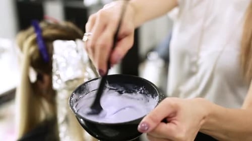 Paint with a Brush in the Hands of a Hairdresser