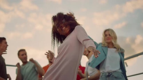 Enthusiastic Young Adults Dancing at Rooftop Party