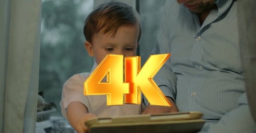 Child and Adult Interact with Tablet Indoors