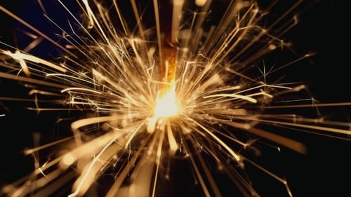 Close-up of Bright Sparkler Emitting Golden Sparks