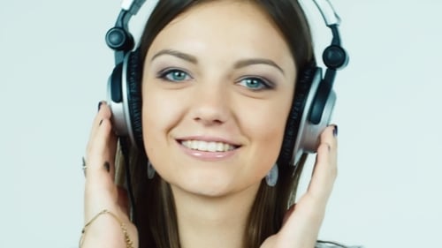 Smiling Woman Listening to Music With Headphones