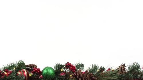 Panning view of wreath garland against white screen on table top