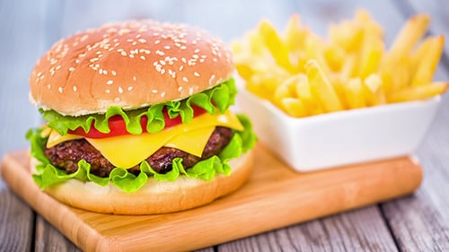 Burger with French Fries on Cutting Board