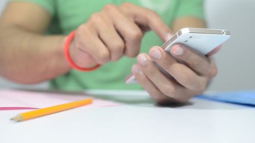 Young Adult Using Smartphone Indoors