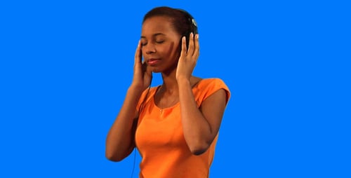 Woman Enjoying Music With Headphones Against Blue Background