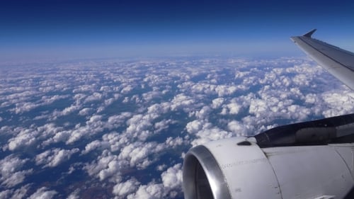 Airplane Flies Above a Blanket of Clouds