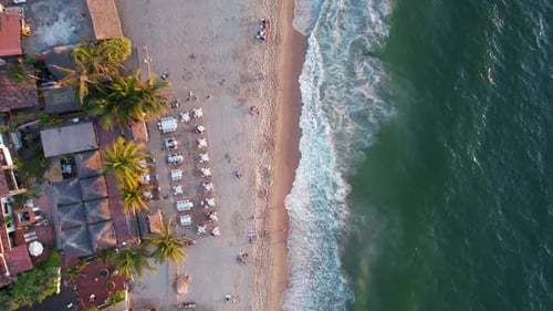 tropical beachfront hotels and resorts at Los Muertos Beach at sunset in Puerto Vallarta Mexico, aer