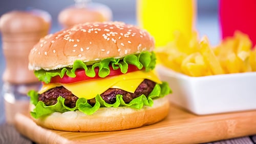 Delicious Cheeseburger and Fries on a Wooden Board