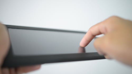 Finger Interacting with Tablet Touchscreen Technology