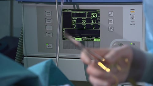 Medical Professional Using Surgical Tools in Hospital