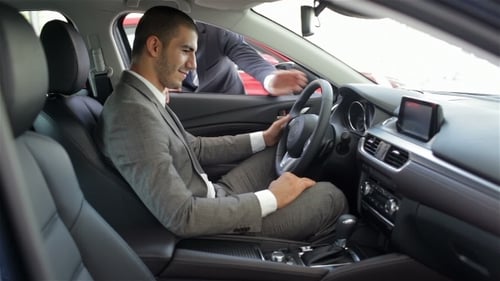 Man Buying Car from Salesman in Dealership