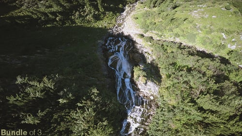 Aerial View of Waterfall in Lush Green Mountains