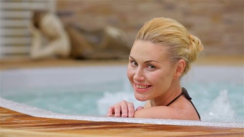 Beautiful Woman Relaxing In a Hot Tub.