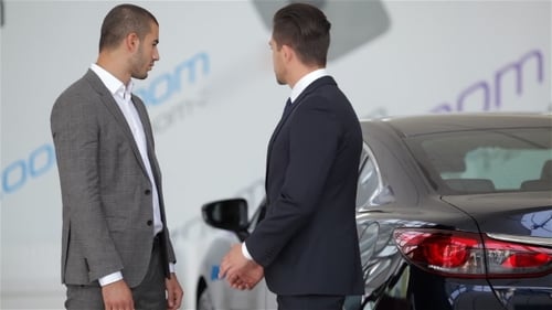Businessmen Agree on Car Deal at Dealership