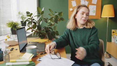 Woman Working in Home Office and Petting Dog