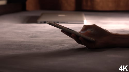 Typing Email On Smartphone In Bed