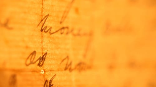 Aged Paper with Hand Written Letters Close Up