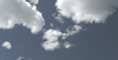 Clouds Moving Slowly Across Blue Sky on a Summer Day