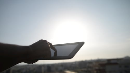 Hand Using Tablet in the City