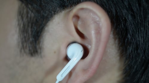 Putting White Earbud into Ear Canal, Close Up
