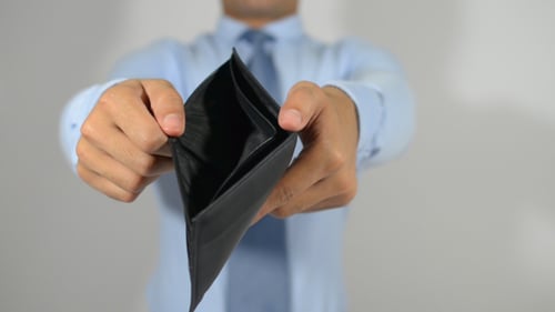 Man Shows Empty Wallet in Studio Shot