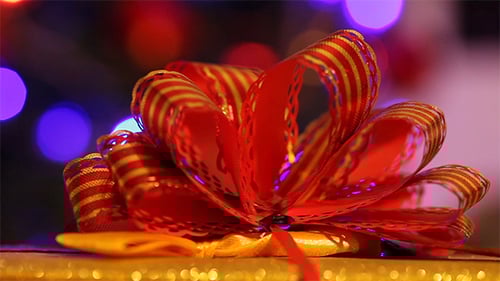 Close Up of Gift with Red and Gold Bow