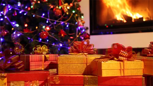 Christmas Gifts by Fireplace and Glowing Tree
