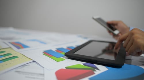 Typing on Tablet, Holding Smartphone in Office